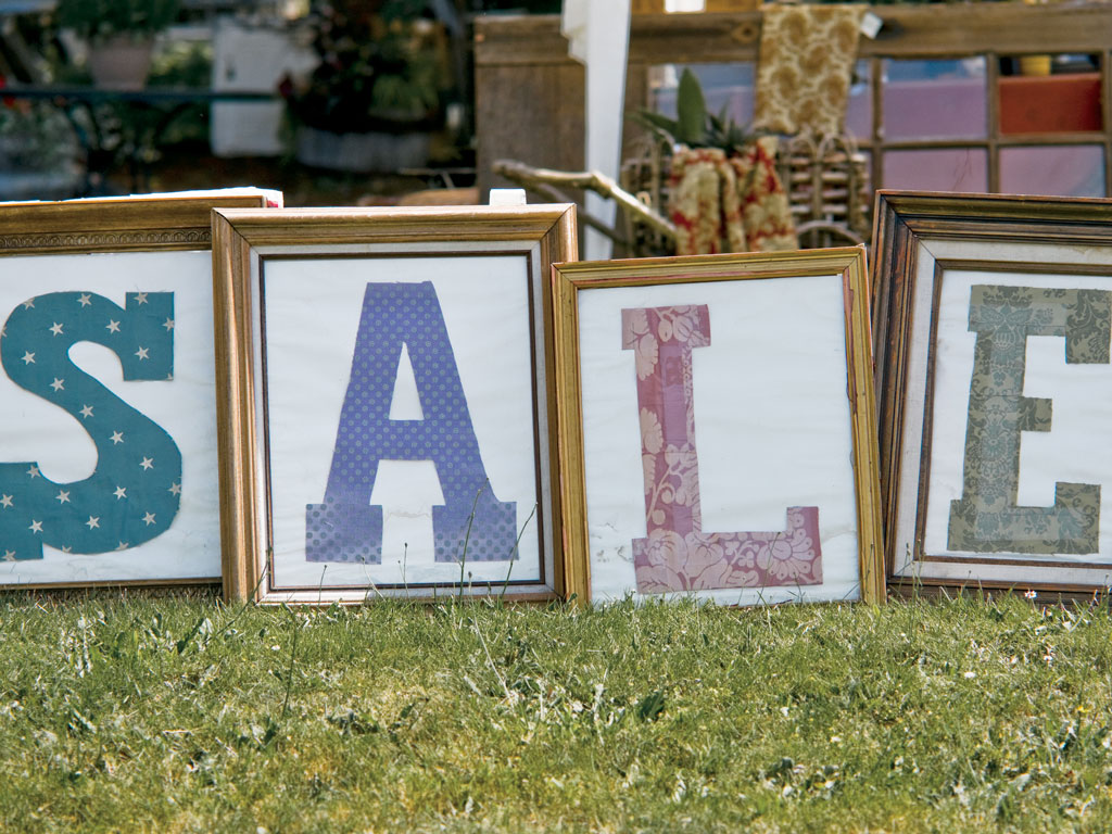 photo frames spelling out "SALE" at a garage sale