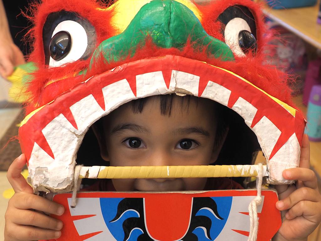 a young boy in a Chinese Lion Dancing costume