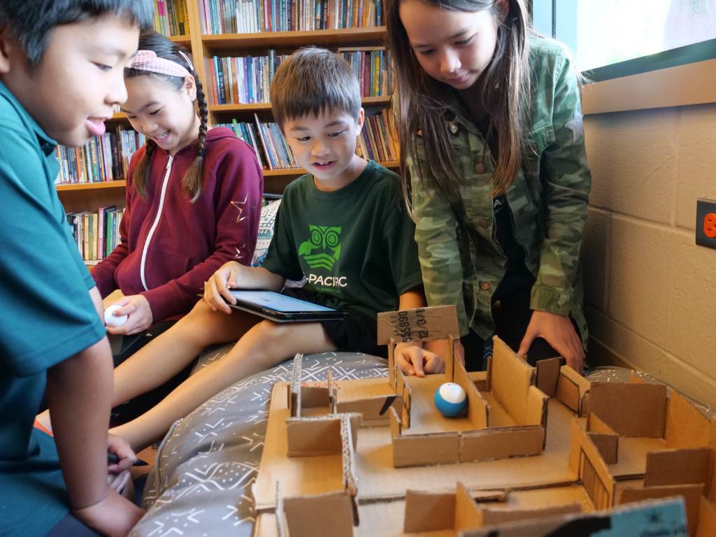 a group of children working on a maze project