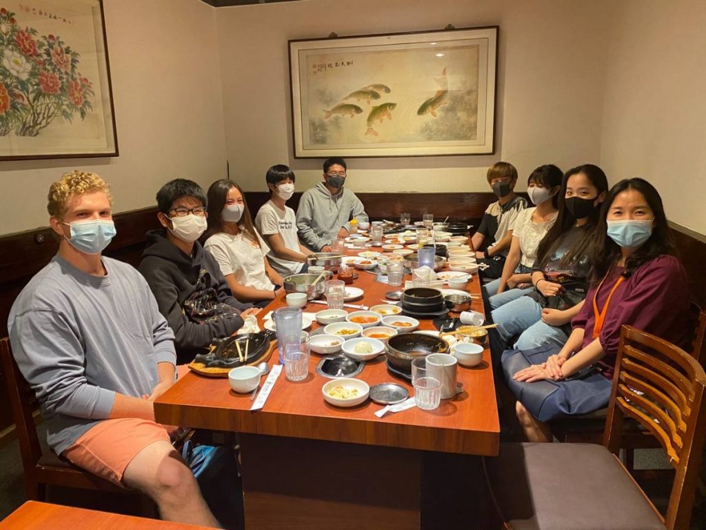 a group of people wearing masks while dining indoors