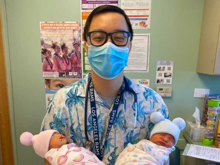 Dr. Vinson Diep holding newborn twins