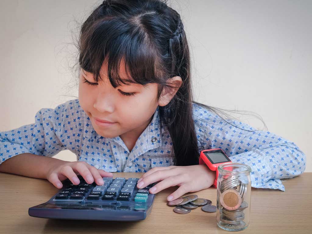 a young girl calculating how much money she's saved