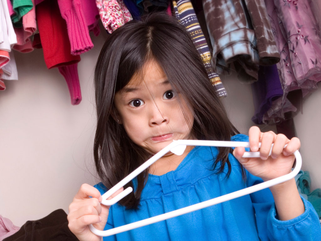 a girl embarrassed that she broke a clothes hanger