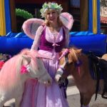 woman dressed in fairy costume with horses