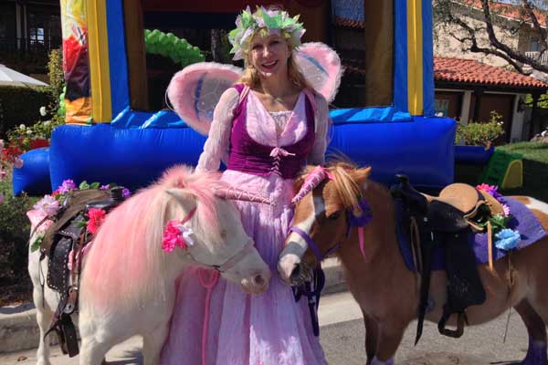woman dressed in fairy costume with horses