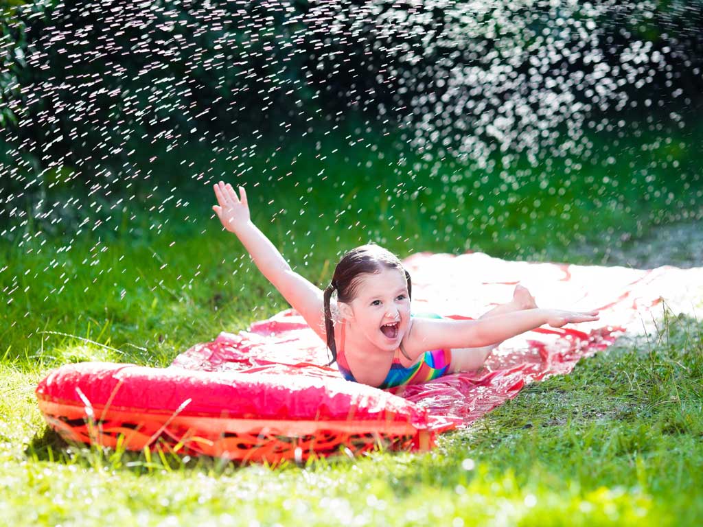 young girl having fun on water slide