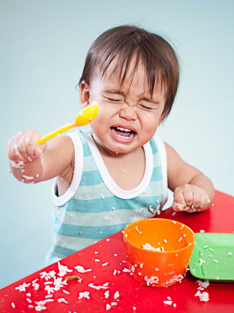 toddler making a mess during dinner