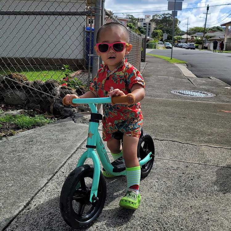kid wearing sunglasses on a scooter