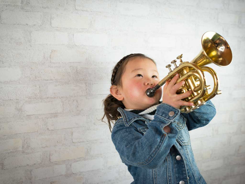 young girl playing trumpet