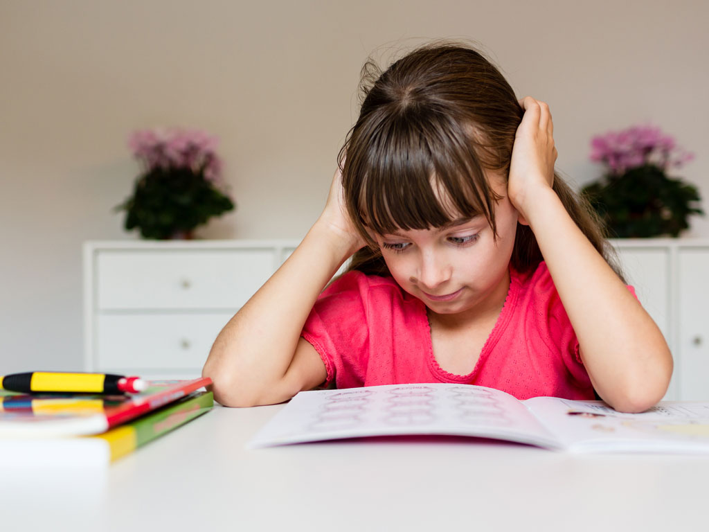young girl frustrated with her homework