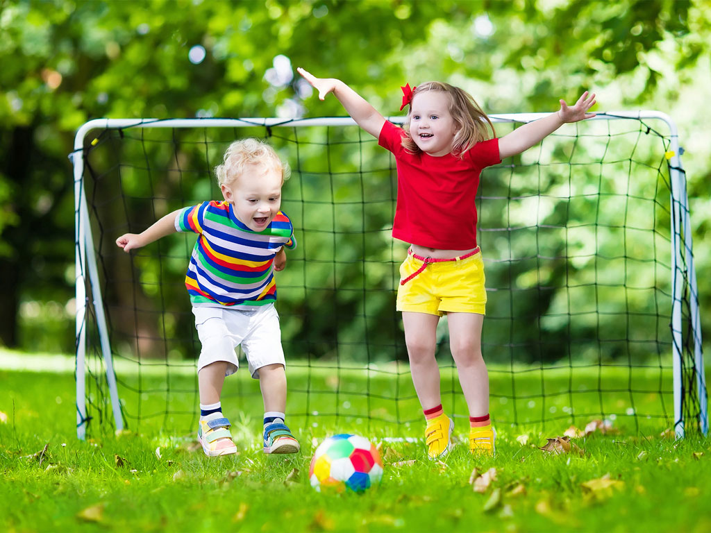 boy and girl playing soccer