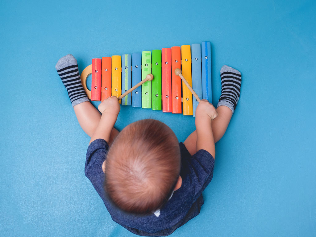 boy playing with xylophone