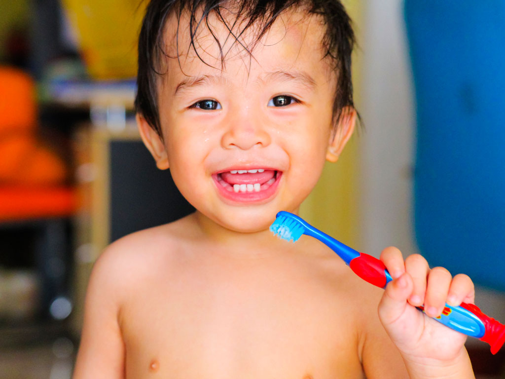child with a toothbrush