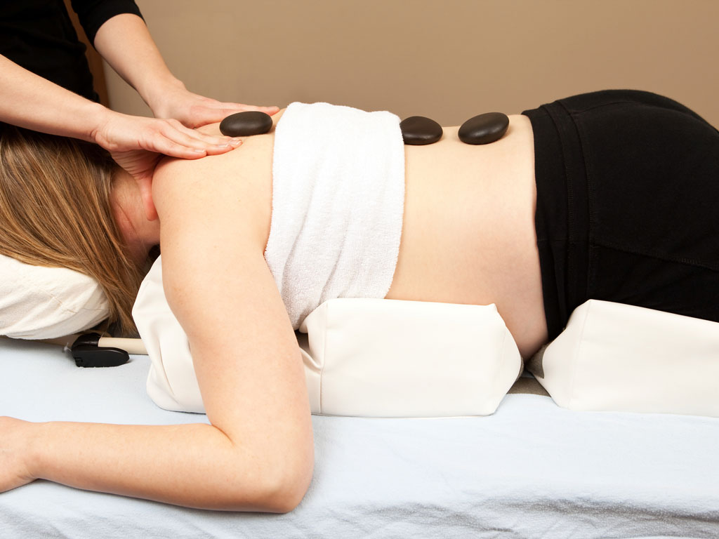 pregnant woman receiving a massage