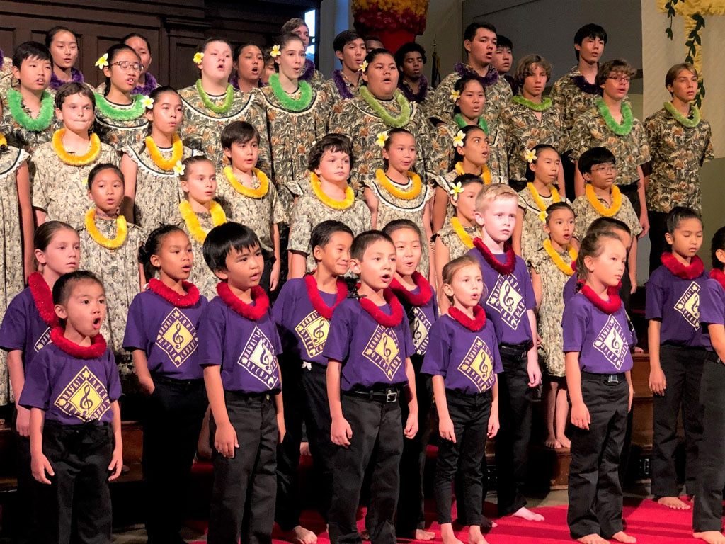 youth of all ages singing in a public performance