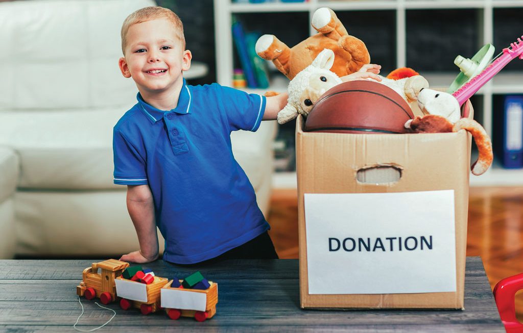 young boy gathering items to donate