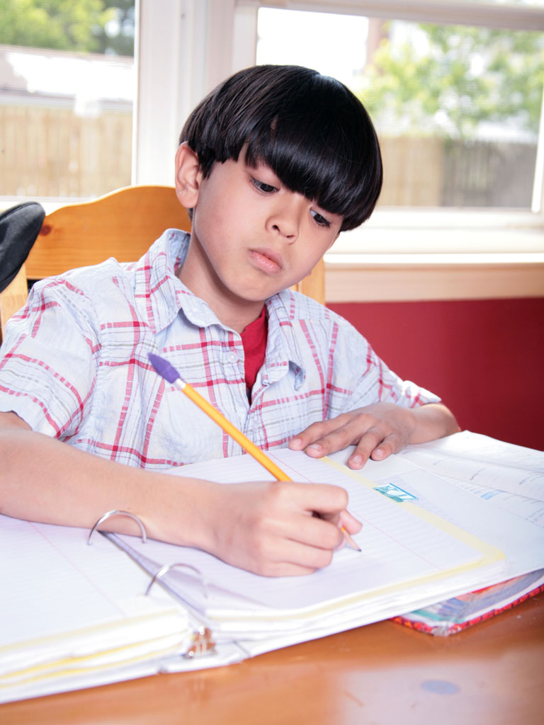 young boy doing homework
