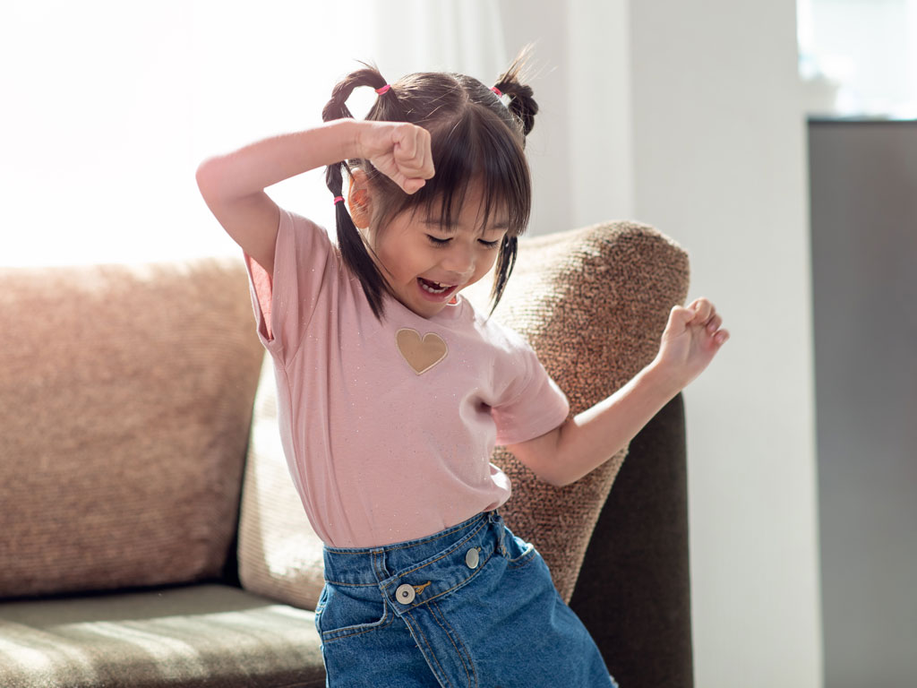 young girl dancing to music