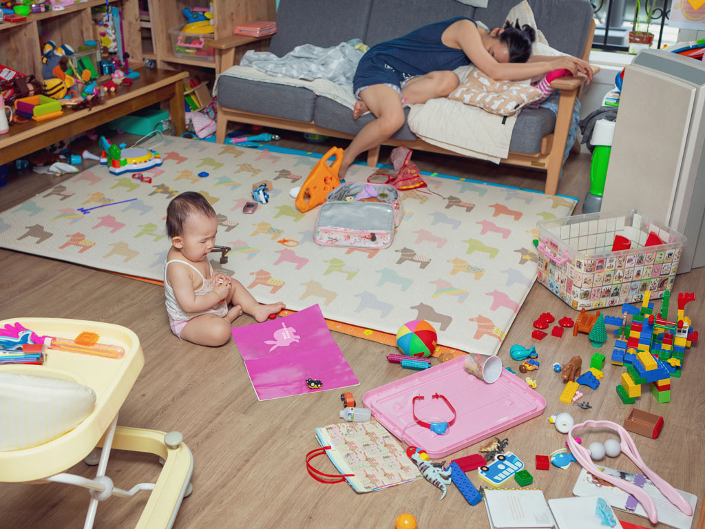 parent exhausted after trying to clean up after toddler