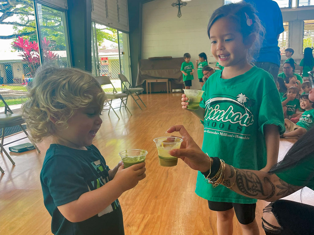 children drinking a green smoothie