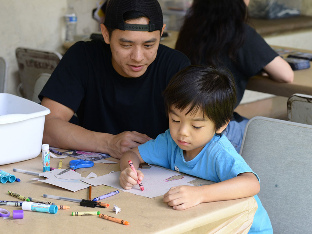 dad and son working on a craft project at the Honolulu Museum of Art