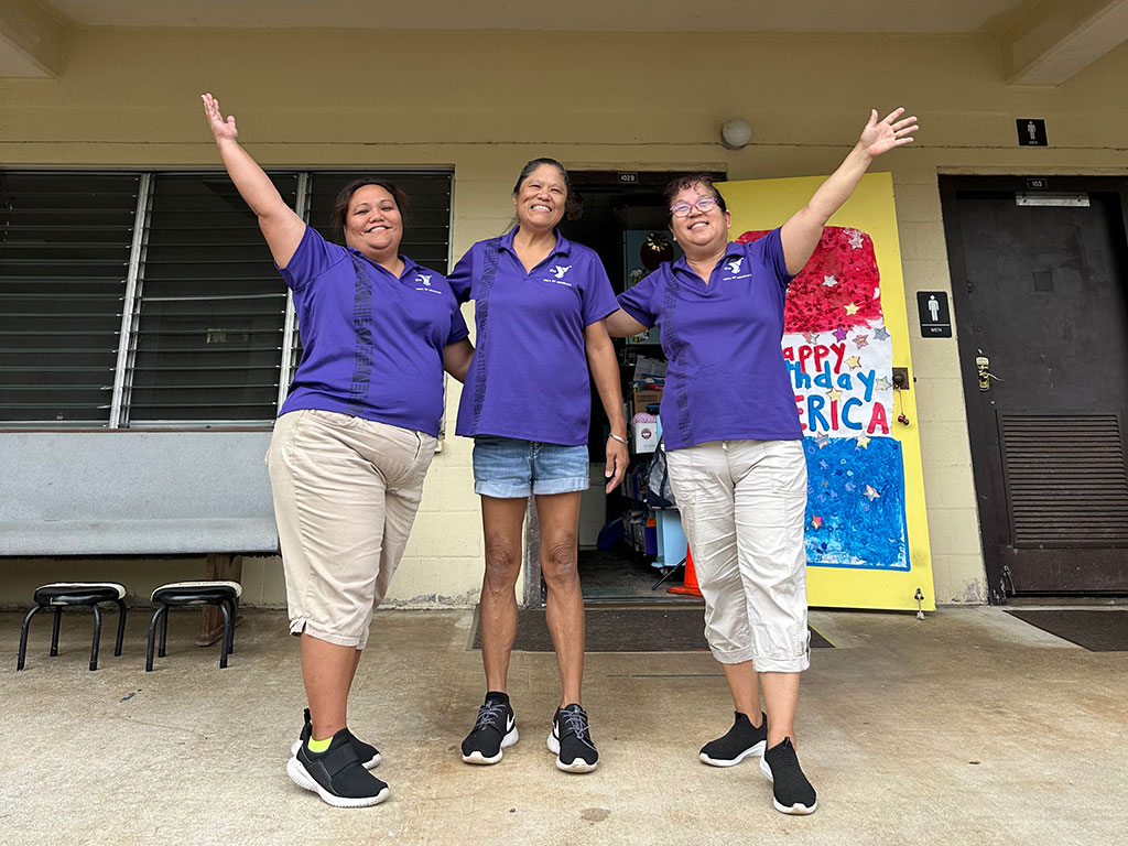 three female preschool teachers standing in front of their classroom at YMCA Pali Nu'uanu Preschool