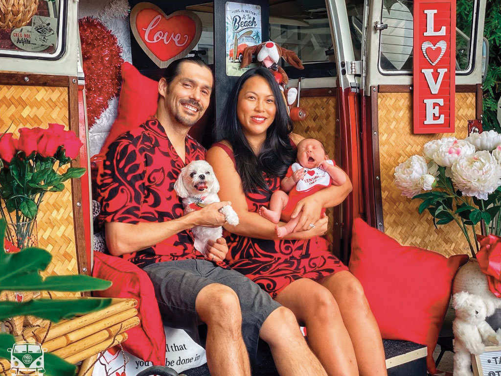 photo of a mom, dad, infant, and dog with Theo the Bus