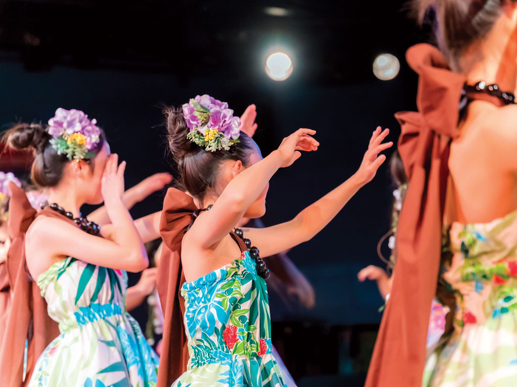 young girls performing hula in public