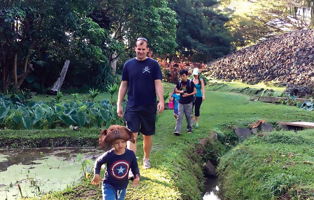 a family exploring the Ulupō Heiau State historic site