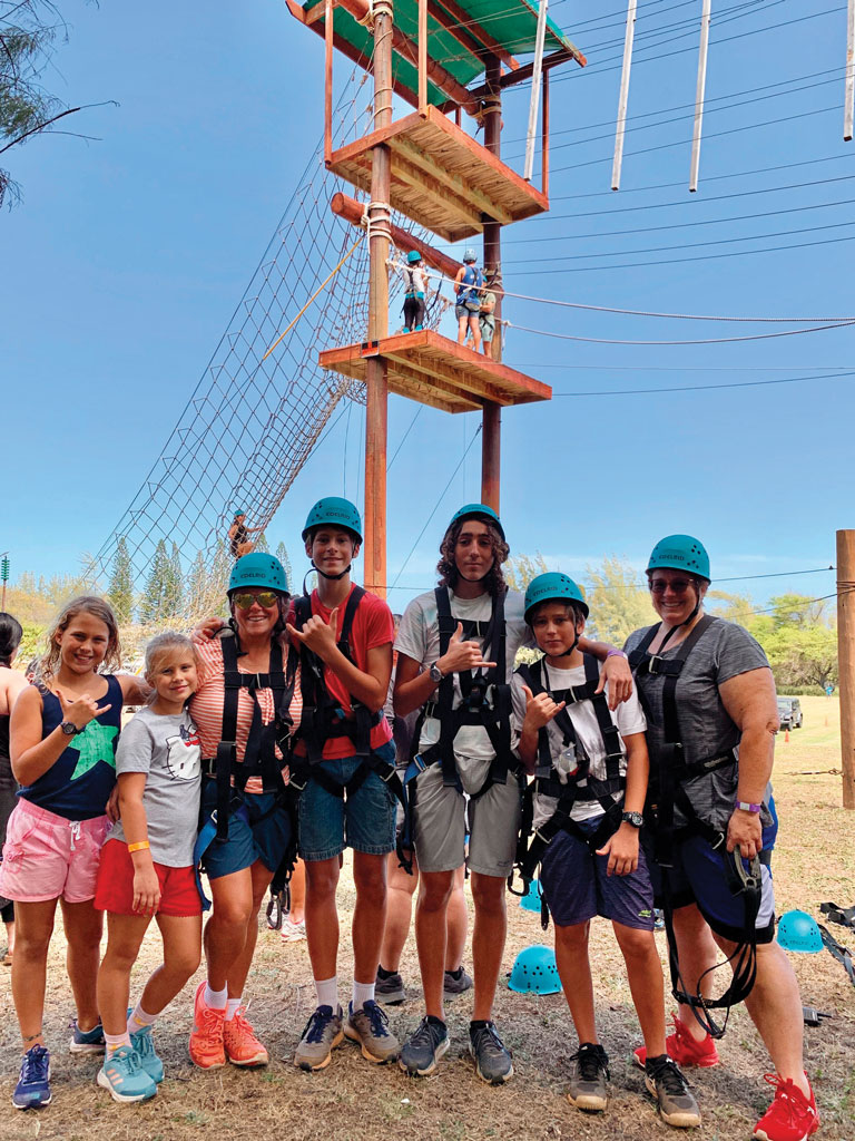 a family finishing the ropes course at Camp Erdman