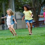 three girls playing soccer