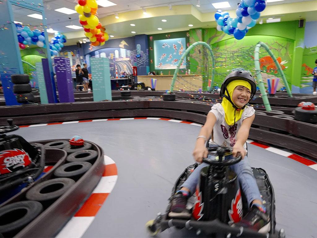 young girl smiling on drift cart at Ohana Draft Lab