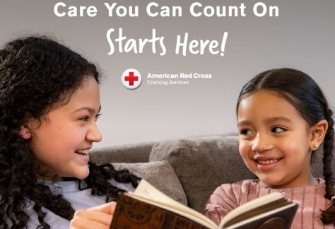 teenager reading to younger girl