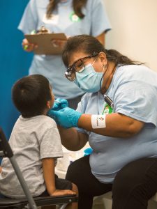 child having teeth inspected by a medical professional