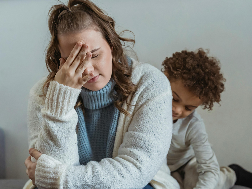A mom upset at her son behind her