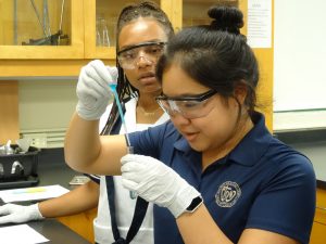 two Sacred Heart Academy students in the lab conducting a science experiment