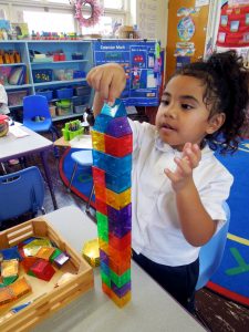 young student with building blocks