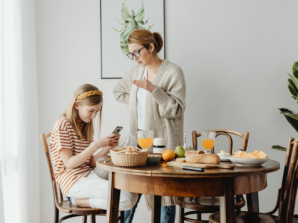 Teenage daughter on the phone not listening to her mom
