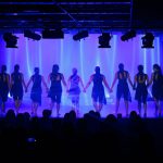 group of females performing on stage