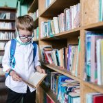 boy reading a book in the library