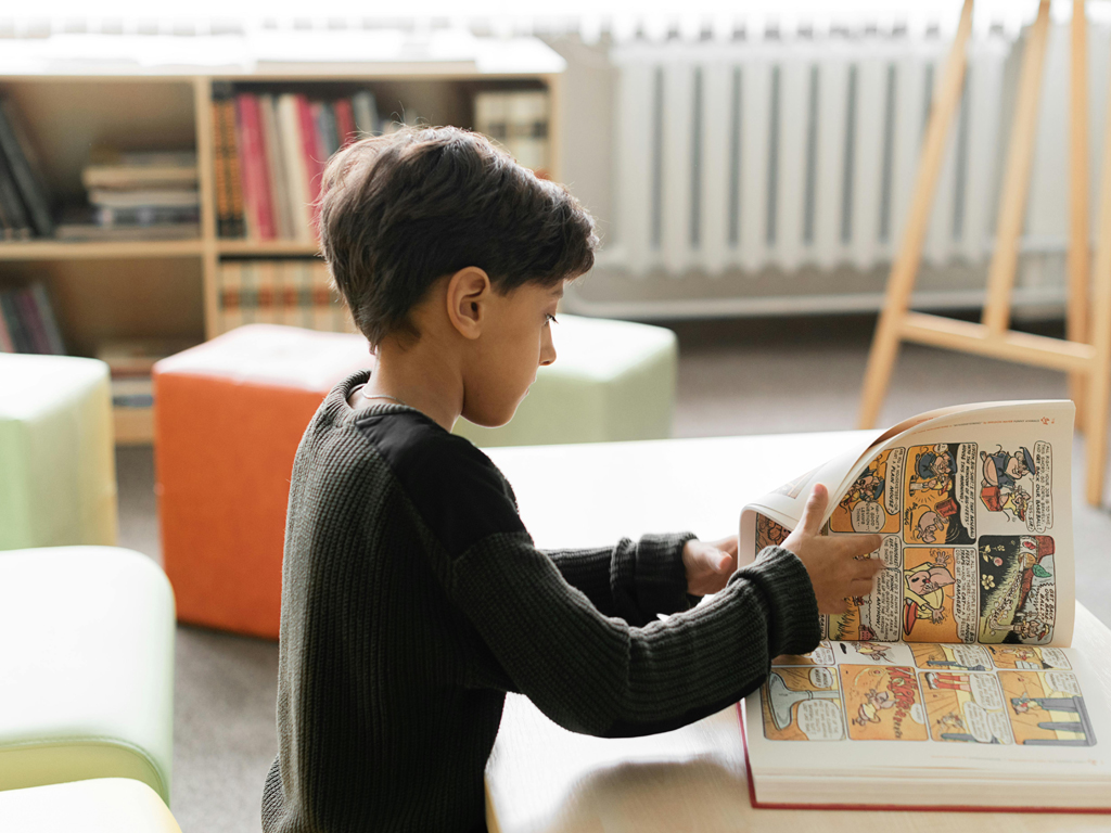 boy reading a book of comics