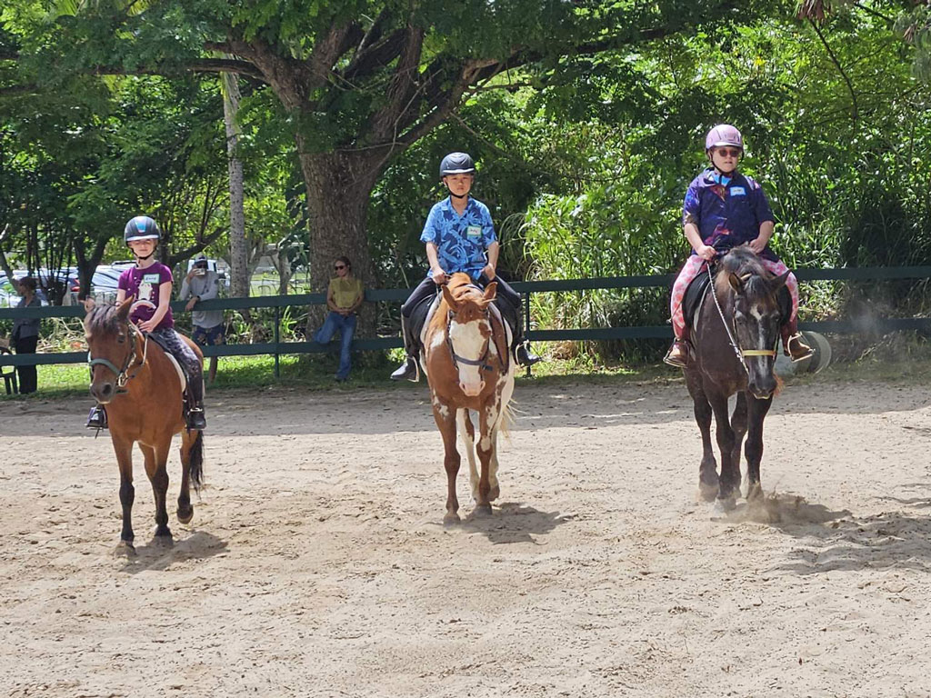 three youths riding horses at Therapeutic Horsemanship of Hawaii