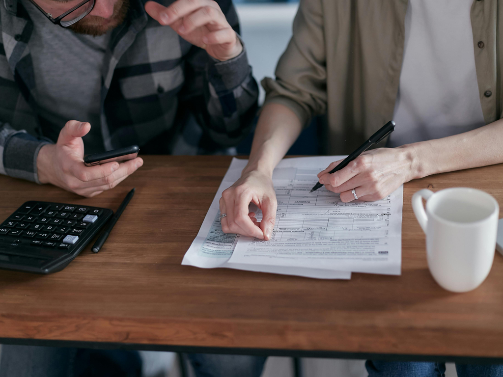 two people signing a legal document