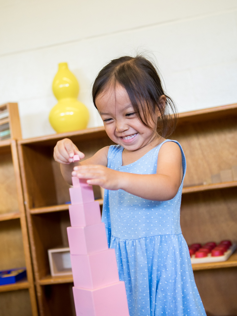 a young girl playing with blocks