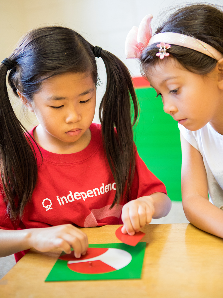 two students learning about fractions