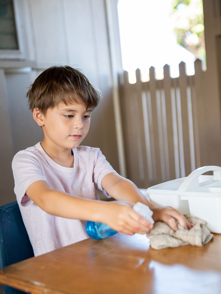 young boy cleaning up