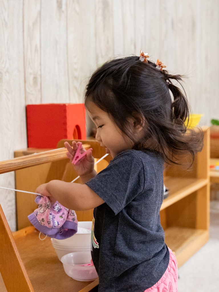 young girl learning how to tidy up