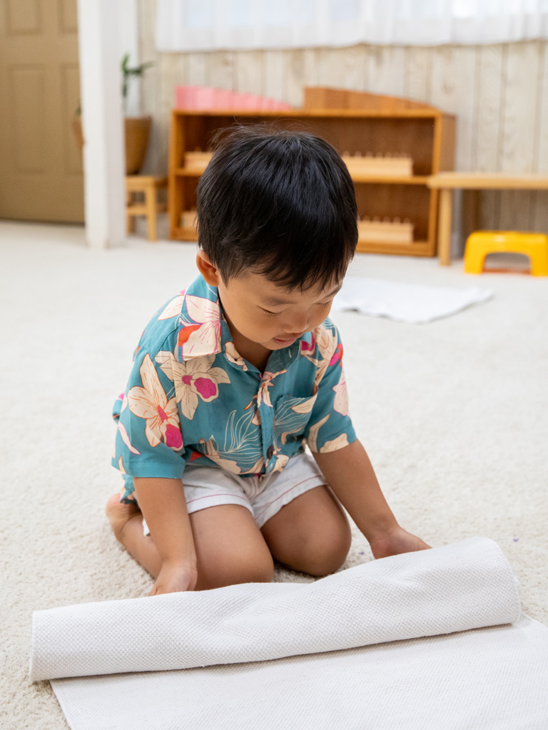 young boy learning how to tidy up
