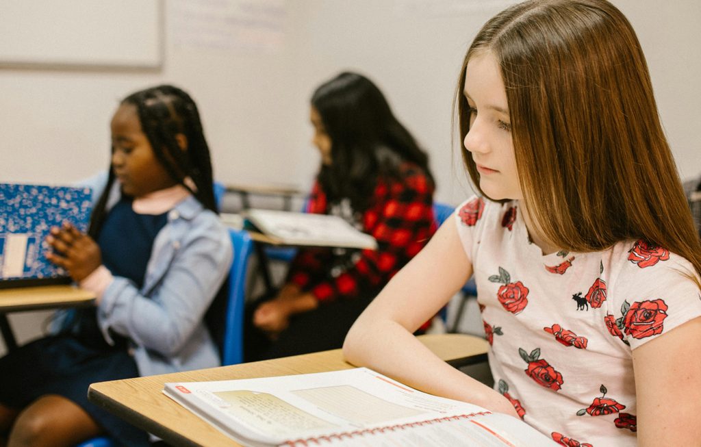 a young girl struggling in the classroom