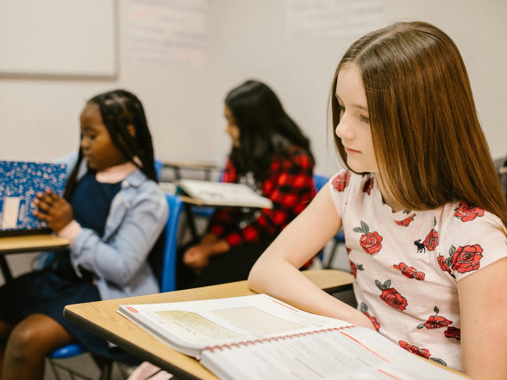 a young girl struggling in the classroom